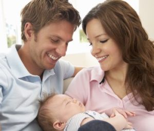happy parents with newborn child